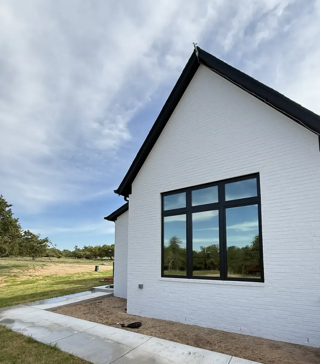 Farmhouse gable window unit with film that mirrors the sky, tinted by EHCO