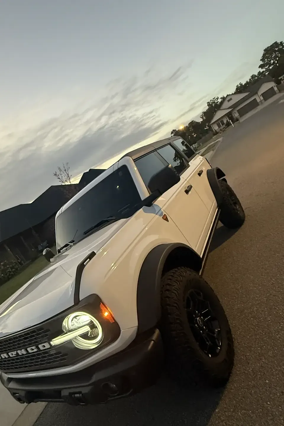 Front view of the same Ford Bronco at sunset, showing the finished window tint