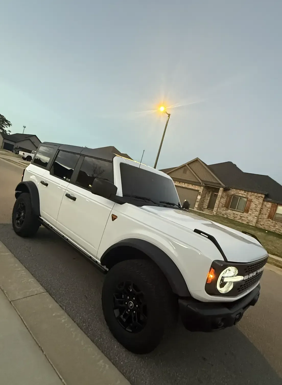 White Ford Bronco Badlands with tinted windows at dusk, tinted by EHCO in Northwest Arkansas