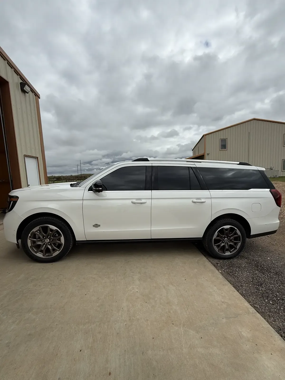 White Ford Expedition Max in full profile with tinted side windows