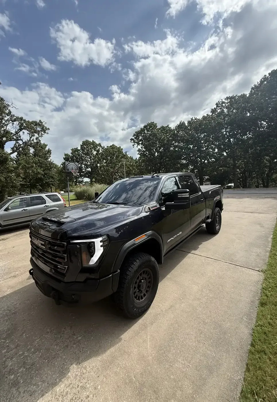 Black GMC Sierra HD AT4X with tinted cab glass, tinted by EHCO in a customer driveway