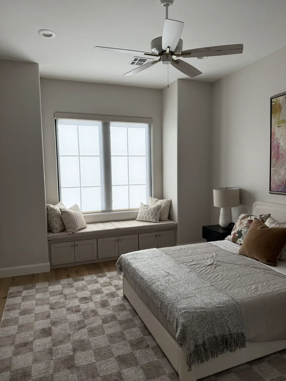 Bedroom with custom roller shades lowered over two windows, installed by EHCO Tint Shade Solutions in Northwest Arkansas