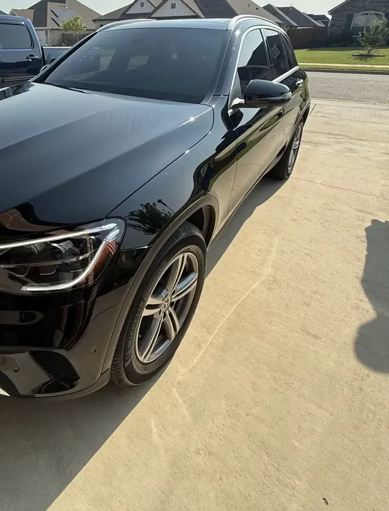 Black Mercedes GLC with ceramic window tint in a customer's driveway, installed on-site by EHCO